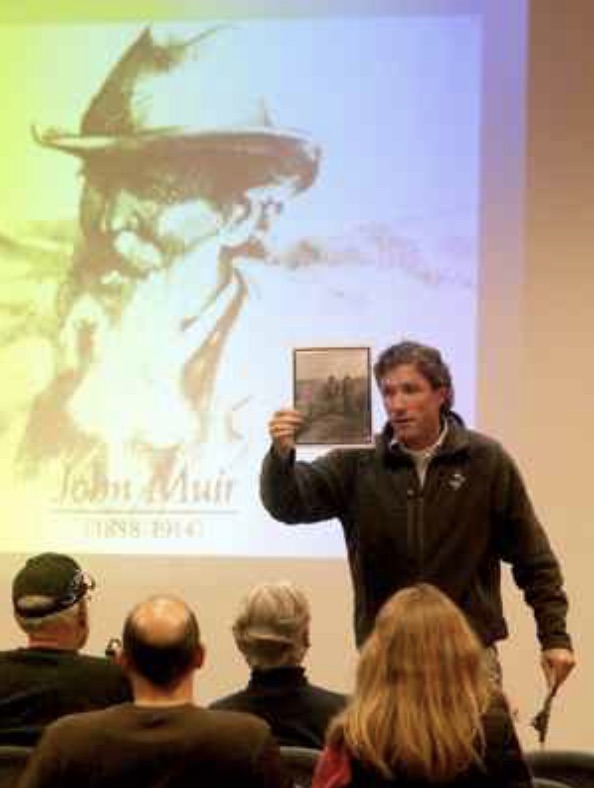 Geauga Park District chief naturalist John Kolar holds up a 1903 photograph of John Muir and President Theodore Roosevelt during his Living History: John Muir presentation.